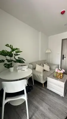a living room with a couch and a table at 1Bed Room Near Airport DMK BTS Swimming Pool Gym Monthly rental in Sathani Lak Si