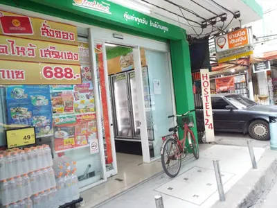 a bike parked in front of a store at Hostel 24 in Bangkok