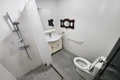 a bathroom with a toilet and a sink at Baan Nara 15 in Bangkok