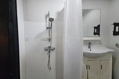 a bathroom with a shower and a sink at Baan Nara 15 in Bangkok