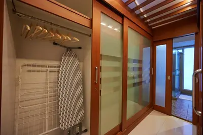 a walk in shower in a bathroom with glass doors at Low-Rise House for Groups Near BTS & EmDistrict For Spacious Cozy Stay in Bangkok