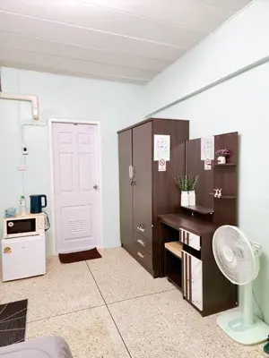 a room with a desk and a white door at 201-STP Homely room Free Wi-Fi and Near BTS in Sathani Bang Khen