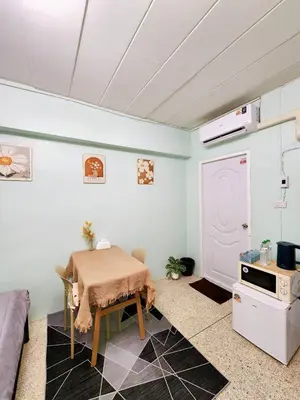 a living room with a table and a kitchen at 201-STP Homely room Free Wi-Fi and Near BTS in Sathani Bang Khen