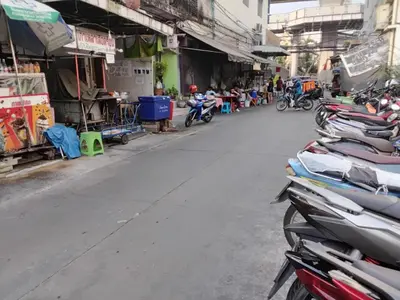 a row of motorcycles parked on the side of a street at Hostel 24 Backpackers in Bangkok