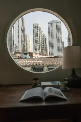 an open book sitting on a desk with a window at nap in a blue moon in Bangkok