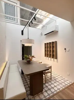 a living room with a table and a couch at Around Ari Hostel in Bangkok