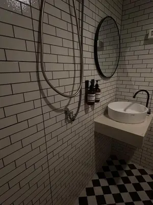 a white bathroom with a sink and a shower at Around Ari Hostel in Bangkok
