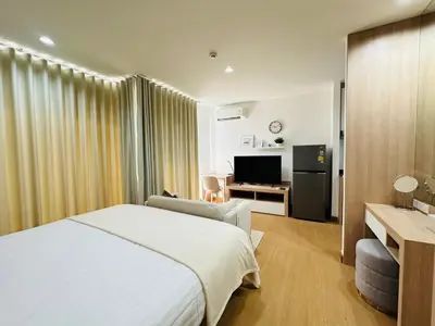 a hotel room with a bed and a television at 6th Avenue Sukhumvit BKK 407 BTS Asoke Nana in Bangkok