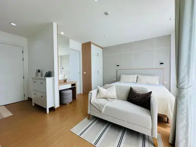 a bedroom with a large white bed and a bathroom at 6th Avenue Sukhumvit BKK 407 BTS Asoke Nana in Bangkok