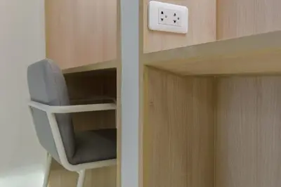 a cabinet with a chair and a clock on it at jasminespace in Khlong San