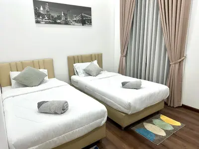 two beds in a room with white sheets and pillows at The Gabriel House in Ban Bang Khen (1)