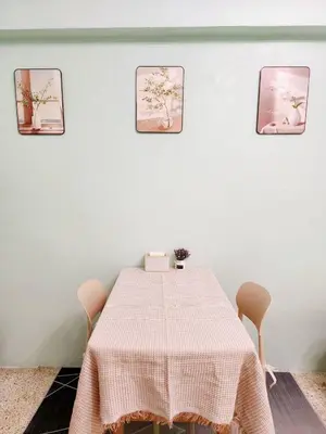 a dining room with a table and three pictures on the wall at 202-STP Homely room Free Wi-Fi and Near BTS in Sathani Bang Khen
