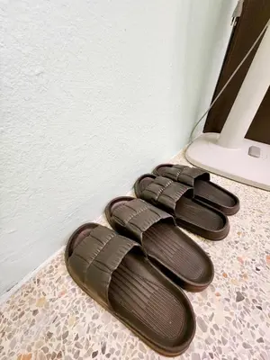 two pairs of sandals sitting on a floor at 202-STP Homely room Free Wi-Fi and Near BTS in Sathani Bang Khen