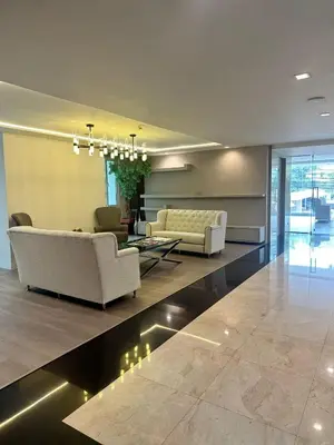 a living room with two couches and a table at Spacious Sukhumvit Condo near EmQuartier in Bangkok