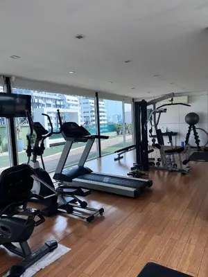 a gym with a bunch of treadmills and exercise bikes at Spacious Sukhumvit Condo near EmQuartier in Bangkok