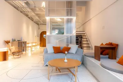 a living room with a couch and a table at Vaeh Viean Silom in Bangkok