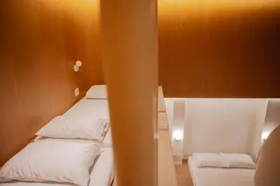 a small room with two beds in a room at Vaeh Viean Silom in Bangkok