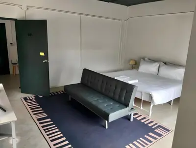 a room with a couch and a bed in it at xx Yellow Place Sukhumvit Soi 2 -เยลโล เพลส สุขุมวิทซอย 2 in Bangkok