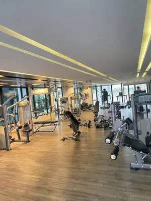 a gym with lots of equipment in a building at Metro luxe riverfront resort style condo in Ban Sai Ma