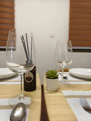 a table with two wine glasses on top of it at Charming 3-Storey house near BTS Onnut Station in Bangkok