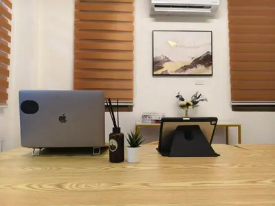 an apple computer sitting on top of a wooden desk at Charming 3-Storey house near BTS Onnut Station in Bangkok