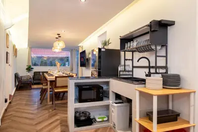 a kitchen with a counter and a dining room at Designer house Chao Phraya River - OH Homes 12 in Bangkok