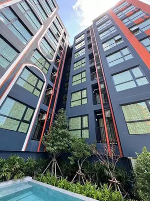an apartment building with a pool in front of it at 1Bed Room Near Airport BTS Big-c Swimming Pool Gym in Bang Khen