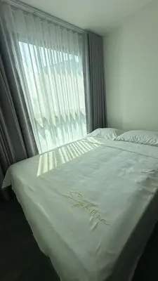 a white bed with a window in a bedroom at 1Bed Room Near Airport BTS Big-c Swimming Pool Gym in Bang Khen