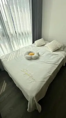 a bed with two towels on it with a window at 1Bed Room Near Airport BTS Big-c Swimming Pool Gym in Bang Khen