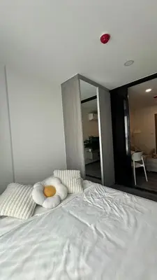 a white bed with two pillows on top of it at 1Bed Room Near Airport BTS Big-c Swimming Pool Gym in Bang Khen
