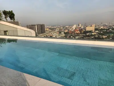 a swimming pool with a view of a city at IDEO Wat Thaphra Bangkok Yai in Bangkok