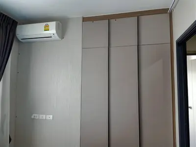 a room with white cabinets and a heater on the wall at Cyber carer NSW in Bangkok Yai