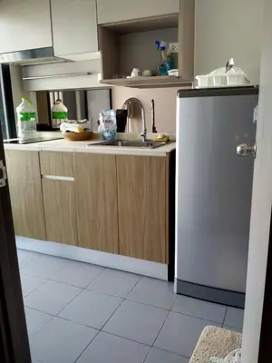 a kitchen with a sink and a refrigerator at Cyber carer NSW in Bangkok Yai