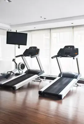 a gym with three treadmills in a room at Spacious and Renovated 1-Bedroom 100m to Nana BTS - 55 sqm in Bangkok