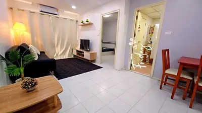 a living room with a couch and a table at River View 03 in Bangkok