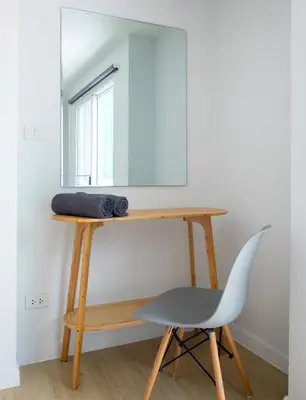 a desk with a chair and a mirror at Baan Khun Pra No 1 Bangkok Duplex in Bangkok