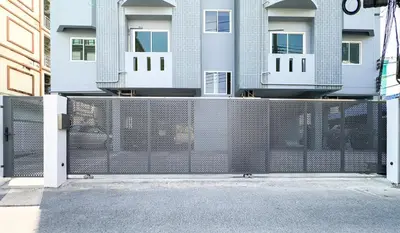 a fence in front of a building at Baan Khun Pra No 1 Bangkok Duplex in Bangkok
