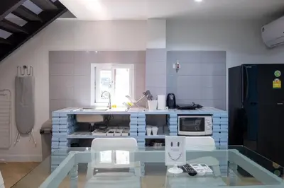 a blue and white kitchen with a counter and a sink at Baan Khun Pra No 1 Bangkok Duplex in Bangkok