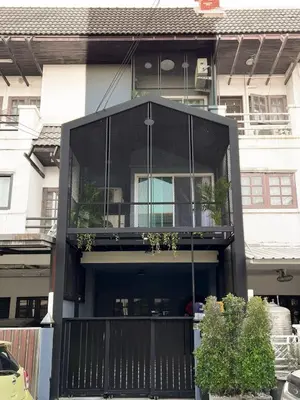 a house with a balcony with plants on it at Enjoyo getaway in Ban Zong Katiam