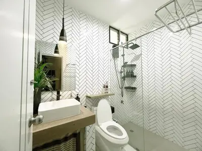 a bathroom with a white toilet and a sink at Enjoyo getaway in Ban Zong Katiam