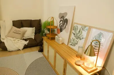 a living room with a couch and a table at Enjoyo getaway in Ban Zong Katiam
