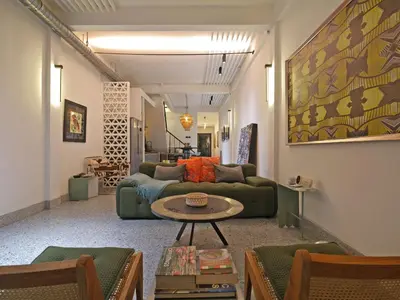 a living room with a couch and a table at Siri Designer 3-Storey Townhouse with Garden and Luxury Amenities in Bangkok
