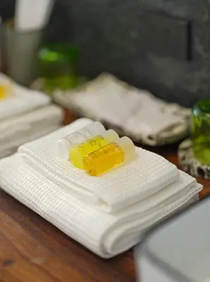 a bottle of medicine sitting on top of white napkins at Siri Designer 3-Storey Townhouse with Garden and Luxury Amenities in Bangkok