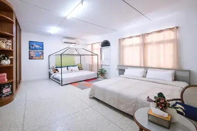 a bedroom with two beds and a large window at Sukhumvit 81 Haven House- BTS Onnut in Bangkok