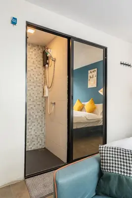a room with a glass door leading to a bedroom at Lachata - Hua Mak in Bangkok