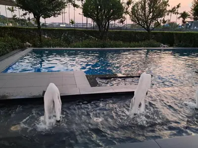 a pool with two dogs playing in the water at MRT SaiMa D condo monthly rent in Ban Sai Ma