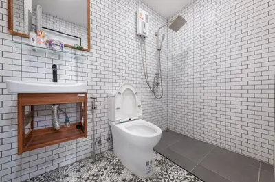 a bathroom with a toilet and a sink at Marshmallow House in Sathani Lak Si