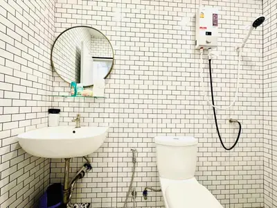 a bathroom with a sink and a toilet and a mirror at Marshmallow House in Sathani Lak Si