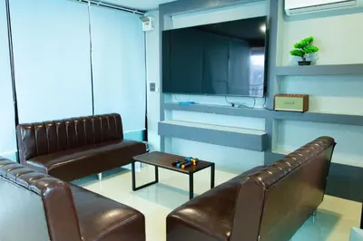 a waiting room with two leather chairs and a table at Cabanaz Pool Villa in Ban Zong Katiam