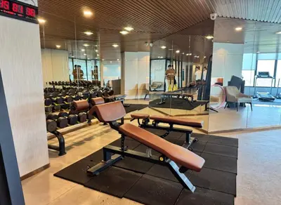 a gym with rows of exercise equipment in a building at Beautiful Studio Room Near MRT in Bangkok